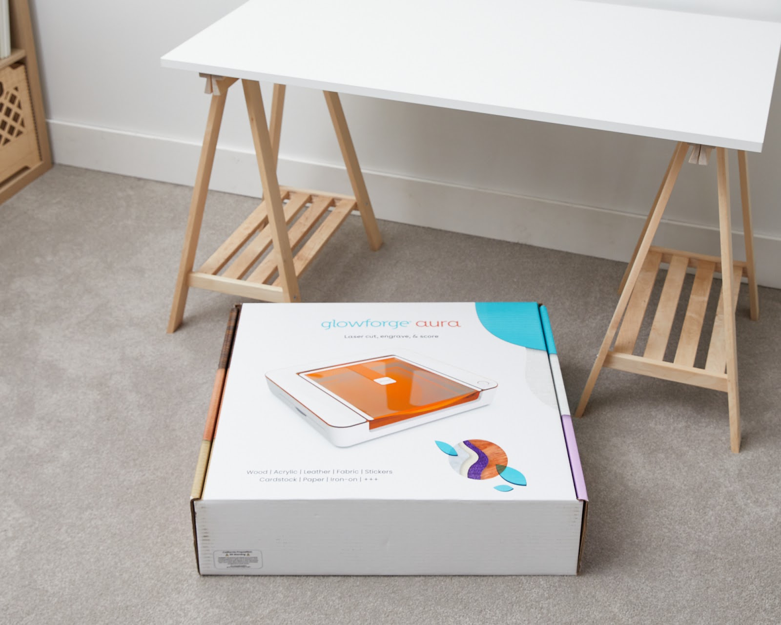 Photo of Glowforge Aura box on the floor, unopened.jpg