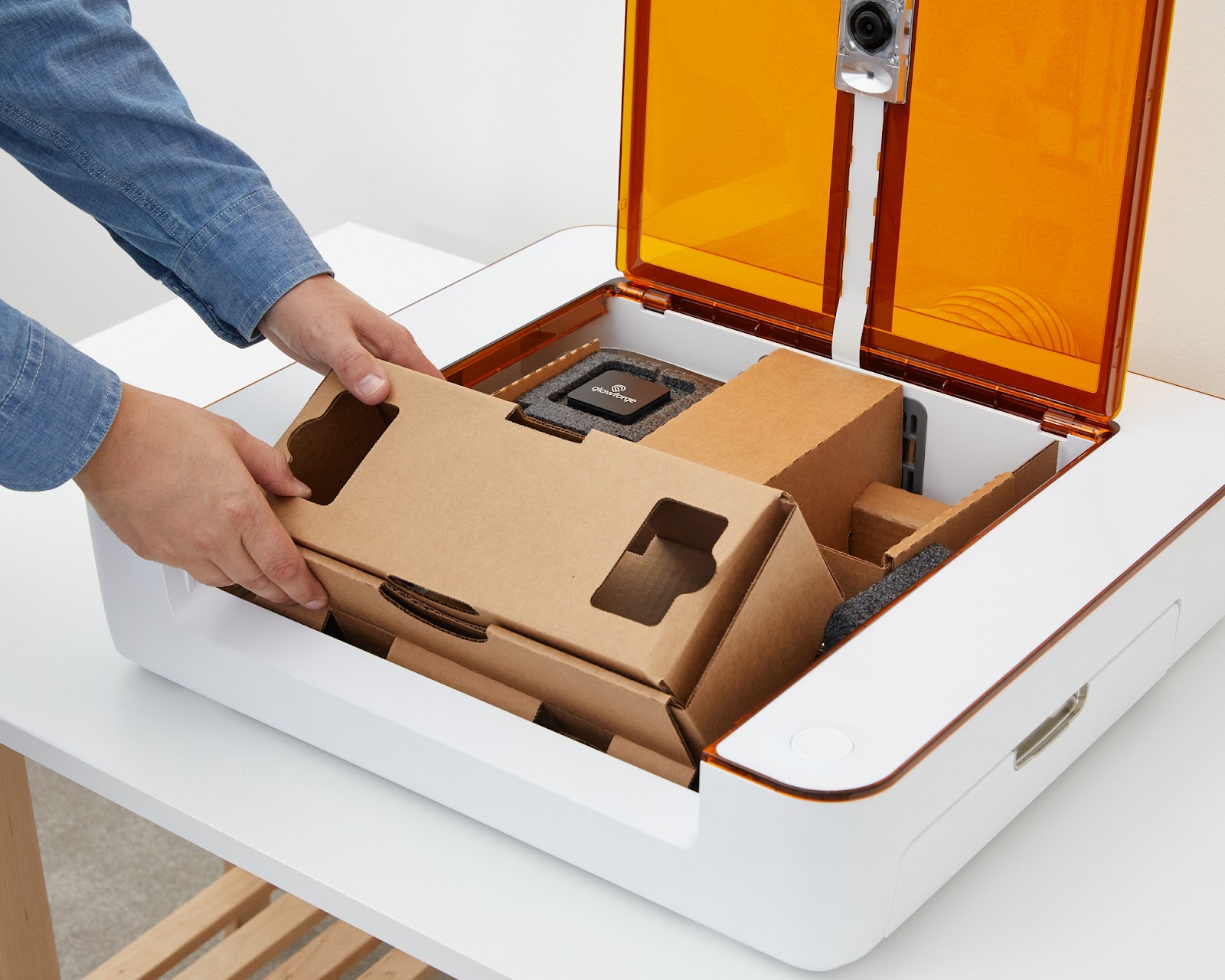 Action shot of the bottom cardboard insert being inserted.jpg