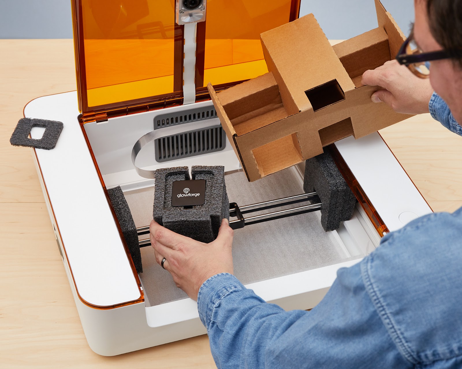Action shot; laser head foam block being held and lifted from the cardboard holder.jpg