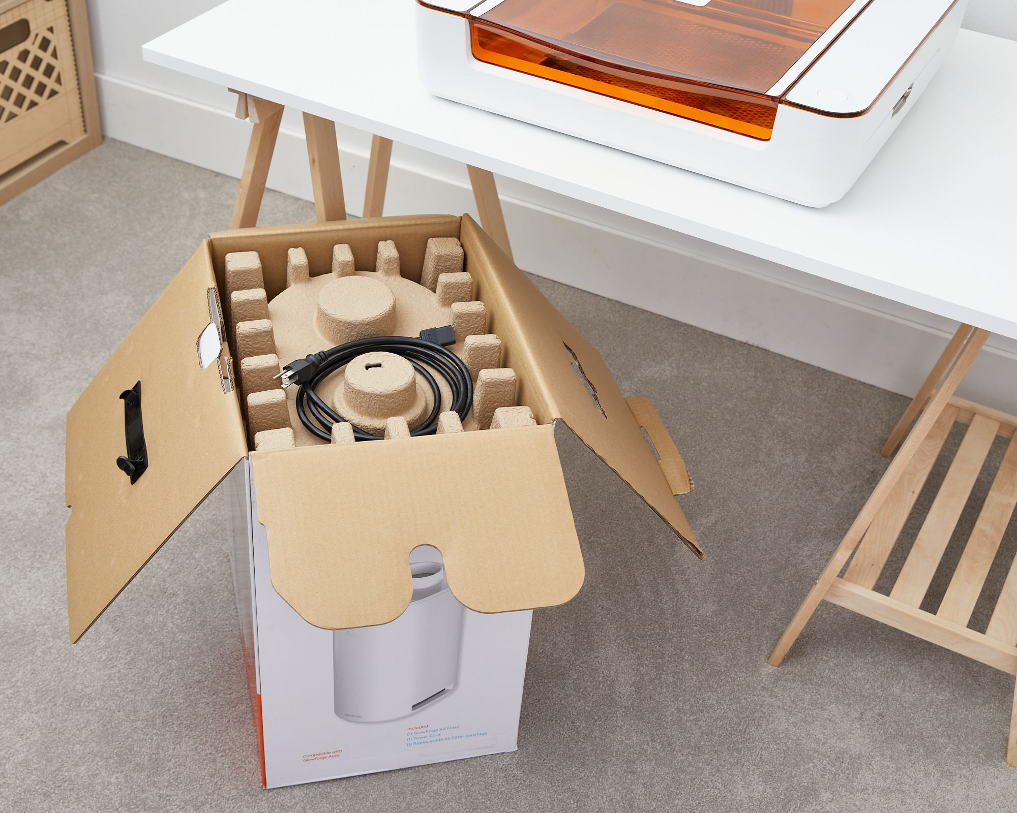 Photo of the opened box with the cardboard insert and power cord.jpg