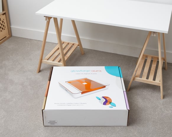 Photo of Glowforge Aura box on the floor, unopened.jpg
