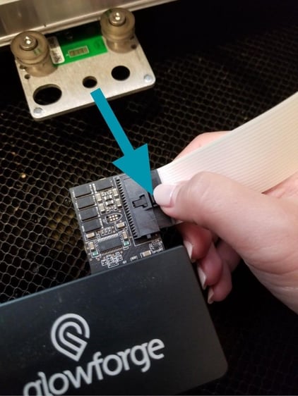 White ribbon cable inserted into Glowforge print head