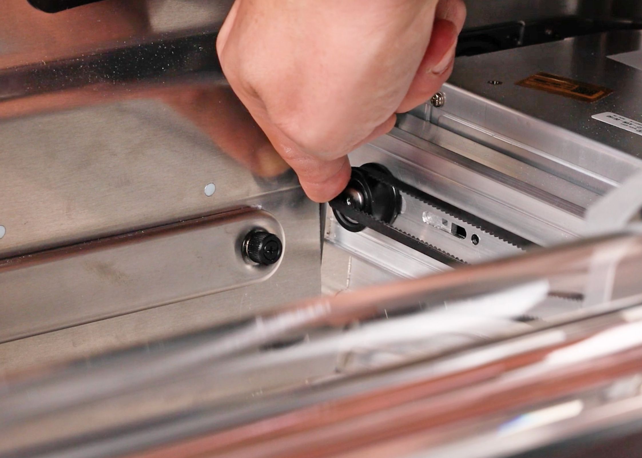 Looping the belt around the idler pulley in the back of the Glowforge