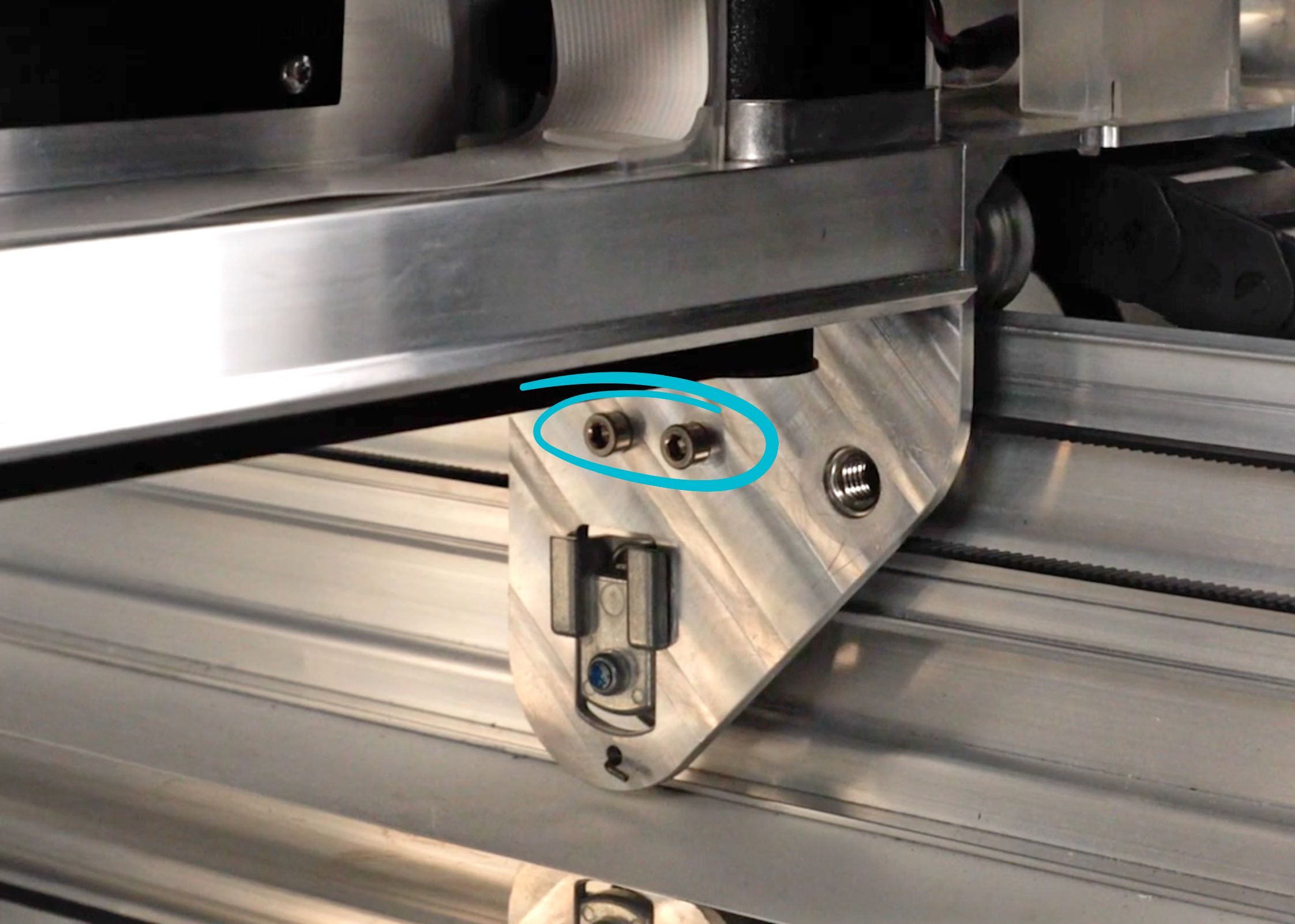 Closer view of two screws below the side of the laser arm