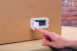 A hand using the tab on the right side to open the handle