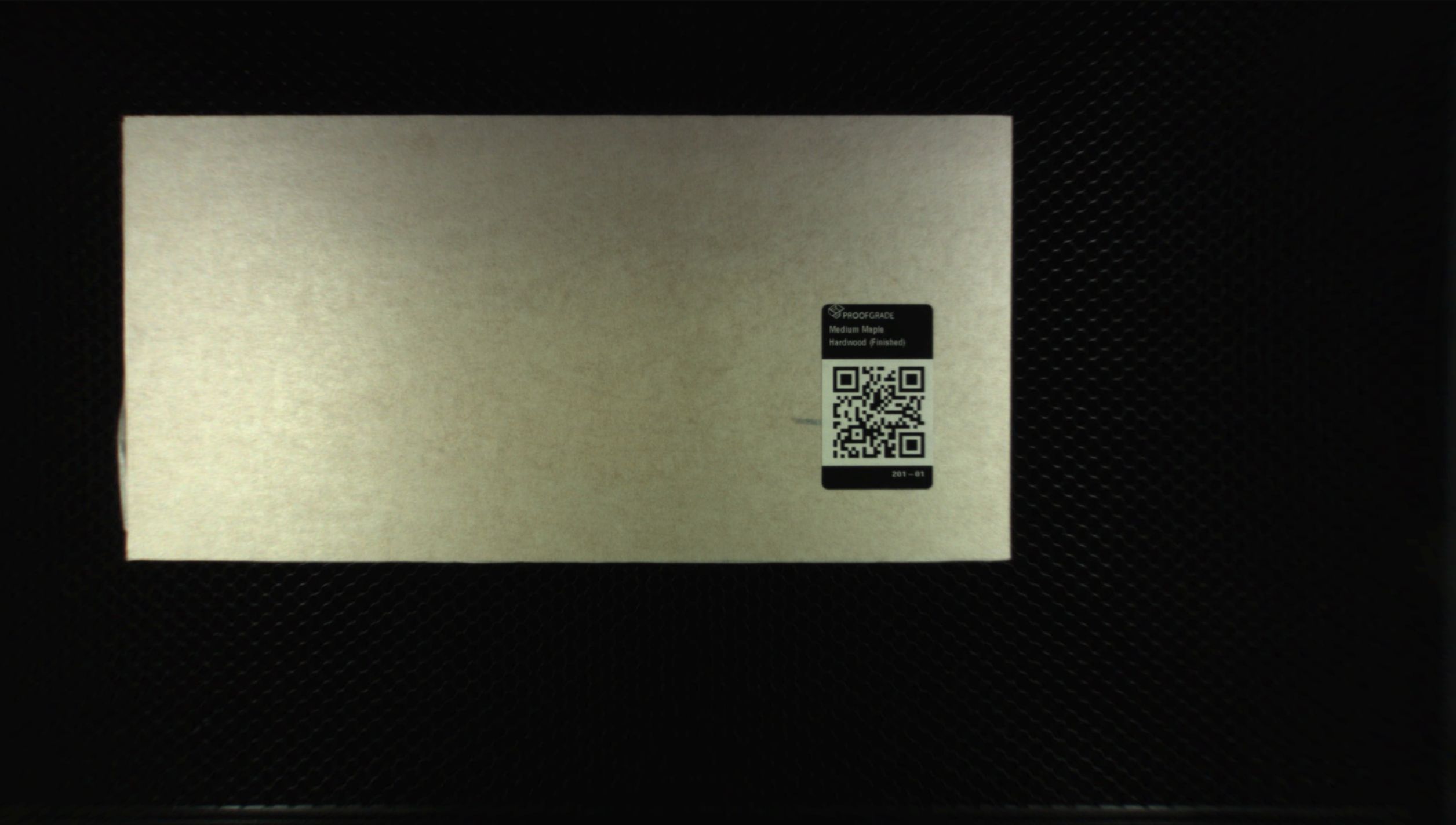 An image generated by the lid camera of a Glowforge showing Proofgrade material in the work area.