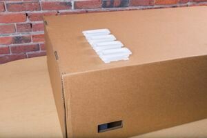 4 handle locks arranged on top of the Glowforge shipping box