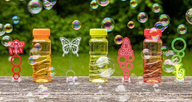 3 bottles of bubble solution, 4 custom made wands and bubbles floating around in the air.