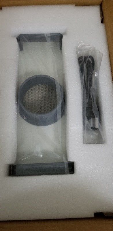 Protective foam on top of the filter in its box. The power cord is in a pocket within the foam
