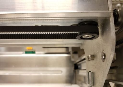 The idler pulley below the laser arm on the right side