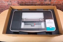 A Glowforge in its shipping box with protective foam under it