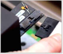 A hand unplugging the cable from the Glowforge printhead