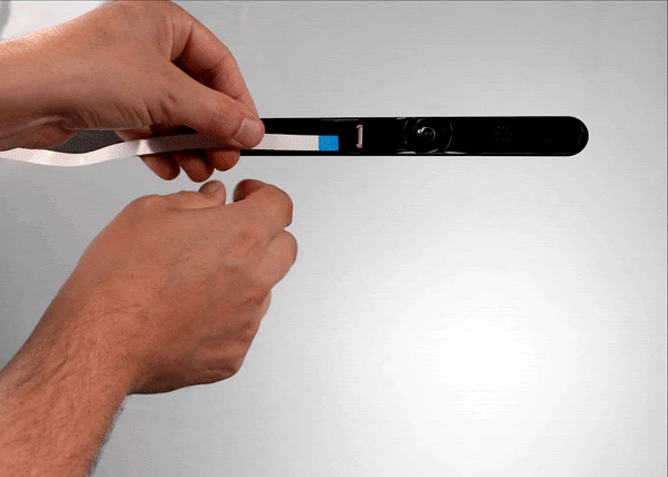 Animated gif of inserting the cable into the socket next to the lid camera and then carefully closing the socket clip