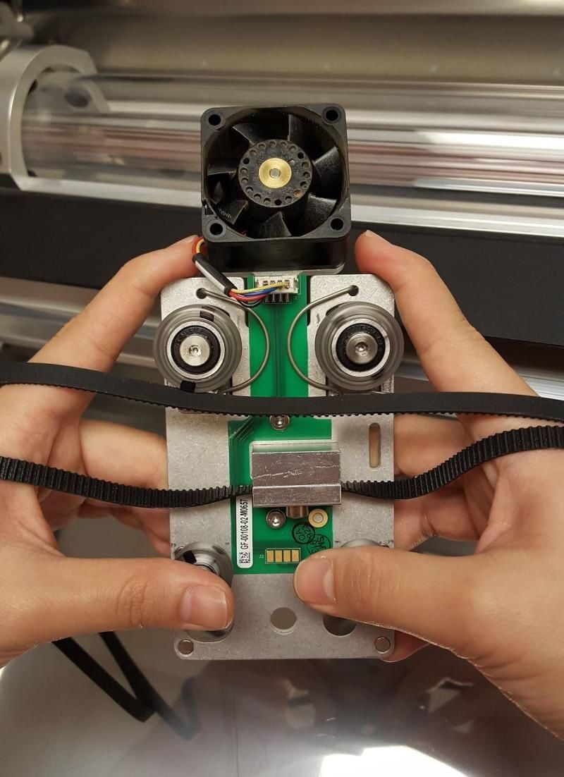 A carriage plate removed from the Glowforge. 4 wheels are visible.