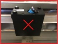 The handle is inserted into the print head instead of the mirror.