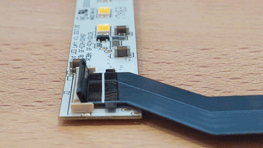 A finger carefully closing the cable clip