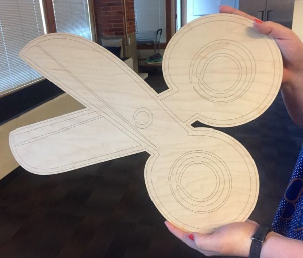 A large, lasercut illustration of scissors