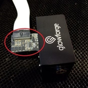 The ribbon cable fully inserted into the print head's socket