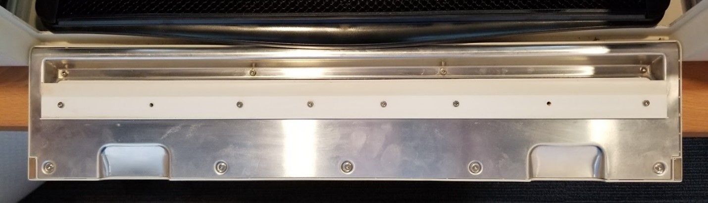 The front door of the Glowforge open, with the Pro Passthrough flap installed