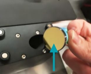 A hand holding the handle of the mirror, with the mirror turned towards the camera.