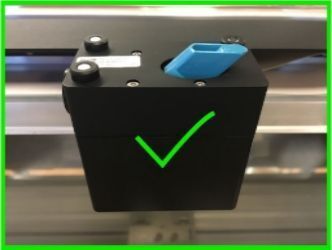 The mirror is fully inserted into the print head. The flat side of the handle with the Glowforge logo embossed onto it is parallel with the top of the print head.