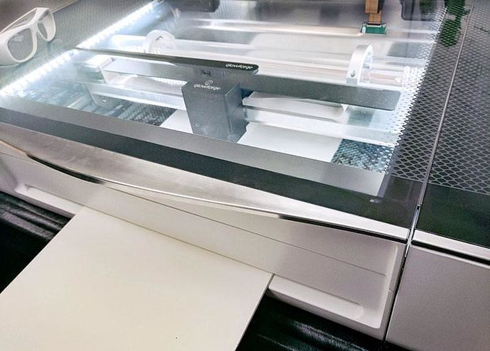Glowforge Pro with material inserted through the Pro Passthrough slot